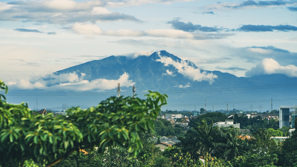 a view of a mountain with clouds in the sky