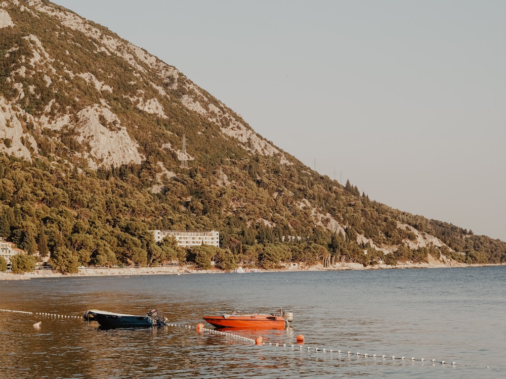 a couple of boats sitting on top of a lake