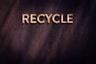 the word recycle written in wood type