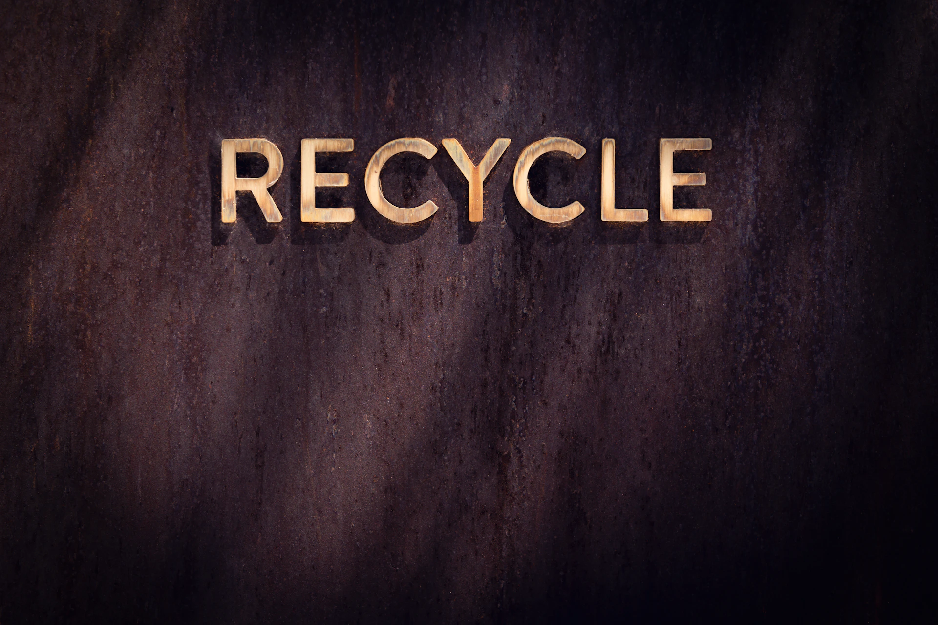 the word recycle written in wood type
