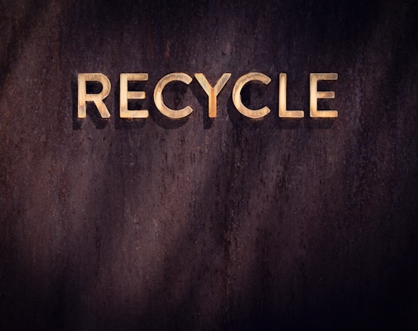 the word recycle written in wood type