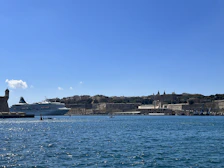 A panoramic view of a cruise ship docked at a bustling Caribbean harbor.