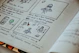 a book with a drawing of a person sitting at a table