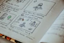 a book with a drawing of a person sitting at a table