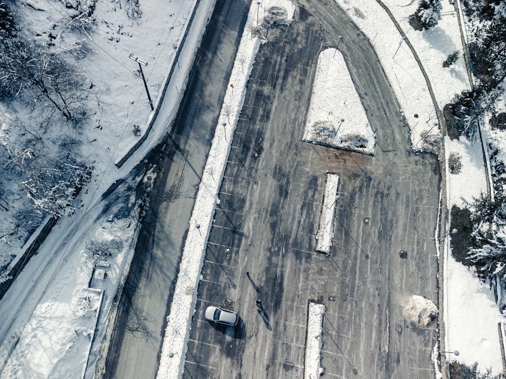 an aerial view of a road in the snow