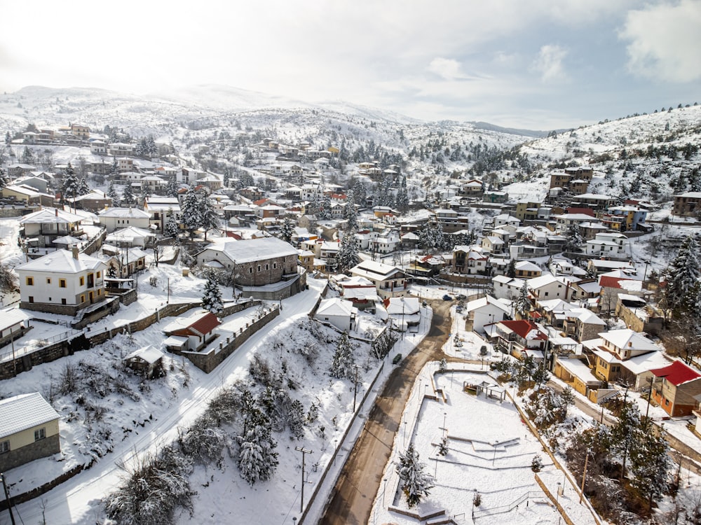 a snow covered town surrounded by mountains and trees