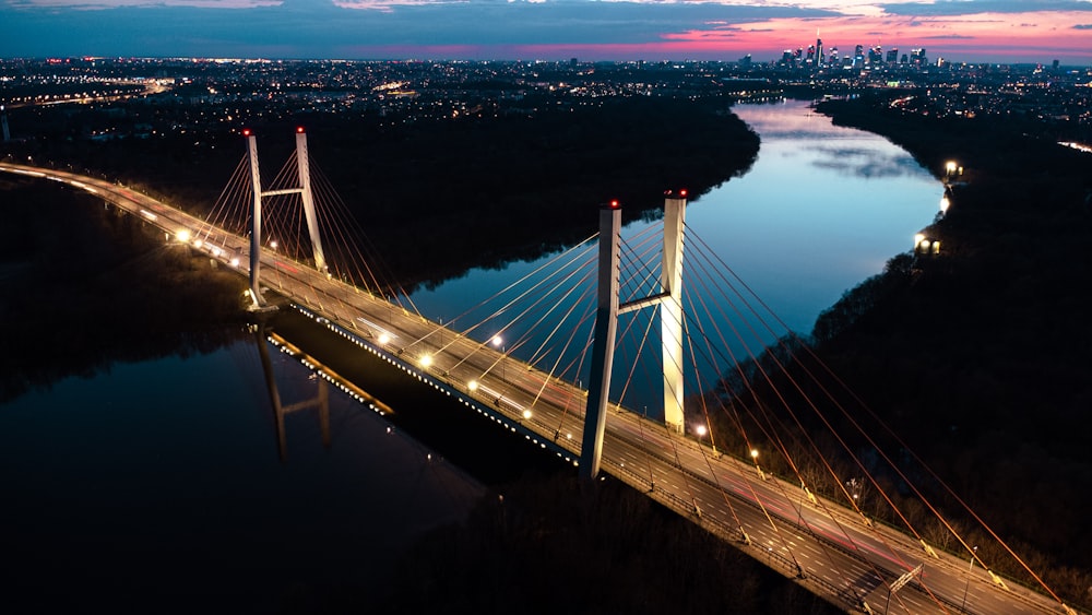 a large bridge over a river at night