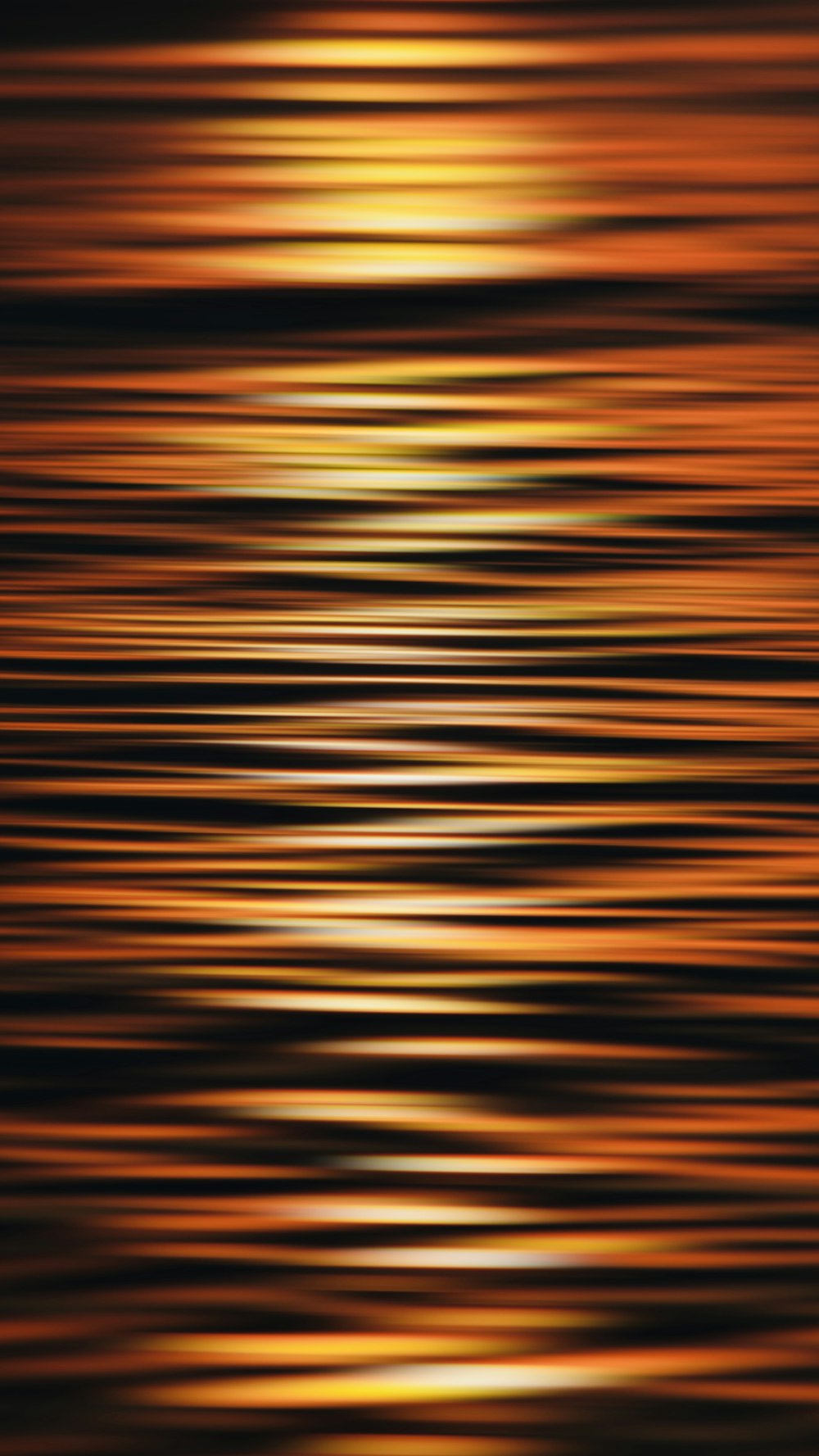 a blurry photo of the sun setting over the water