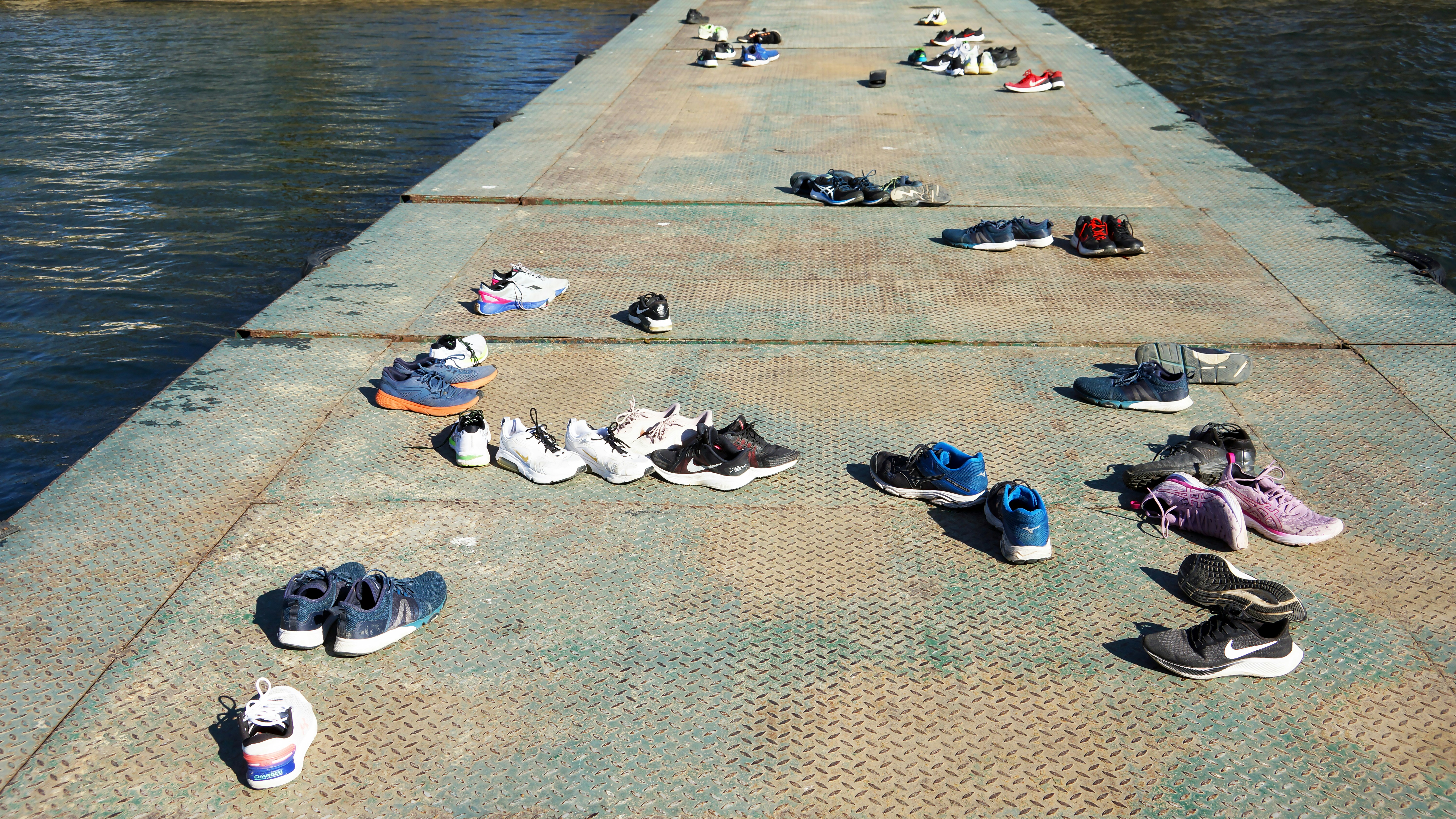 a group of shoes that are sitting on a pier