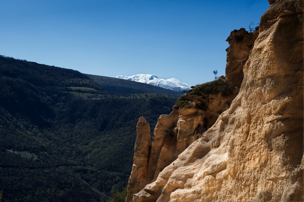 a view of a mountain with a snow capped mountain in the distance