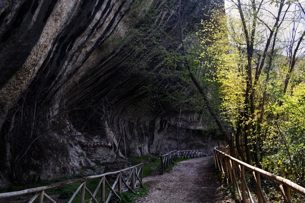 a wooden walkway leading to a large rock formation