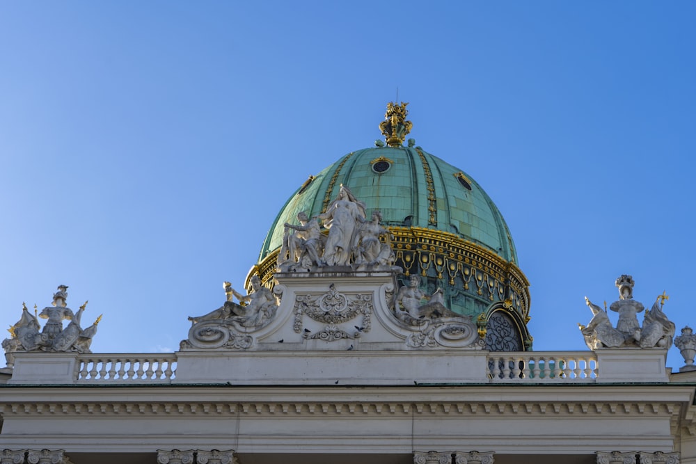 a dome on top of a building with statues on it