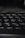 Close-up view of a black computer keyboard, with a focus on the Y, U, H, J, G, and B keys. The lighting is low, creating soft shadows and a slightly blurred depth of field in the background.