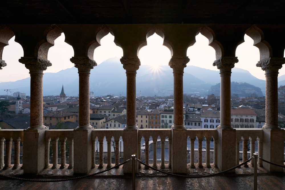 a balcony with a view of a city and mountains