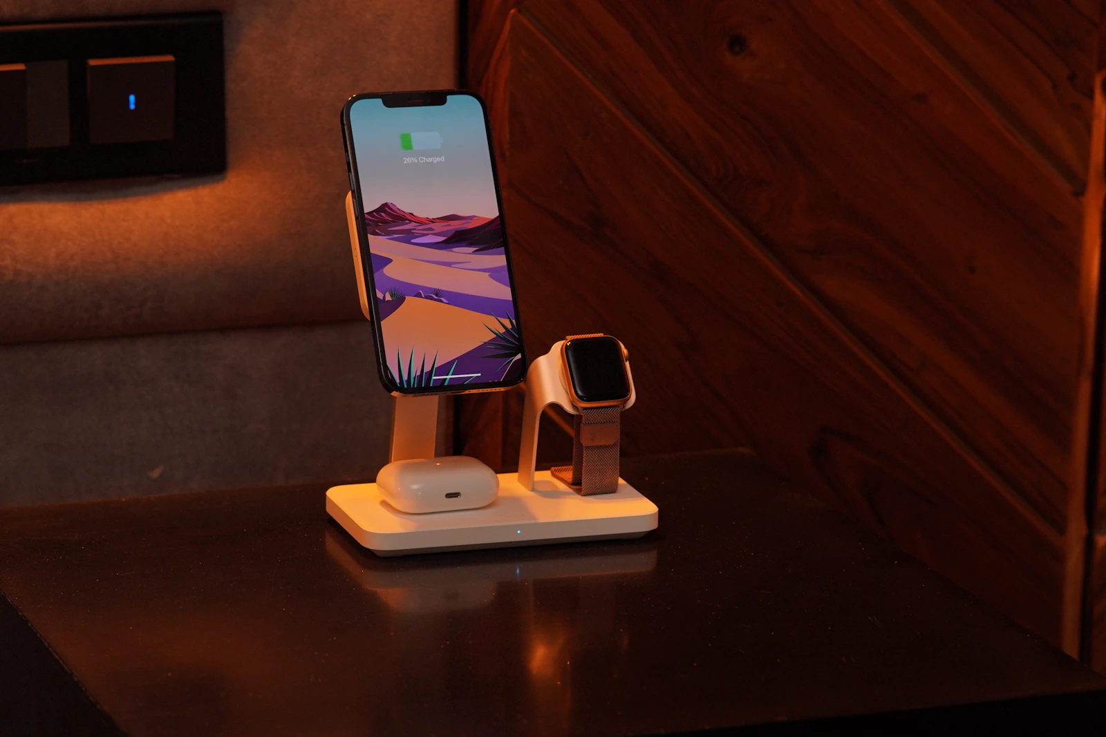 Smartphone, wireless earbuds, and smartwatch arranged on a modern charging station