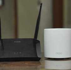 a couple of routers sitting on top of a table