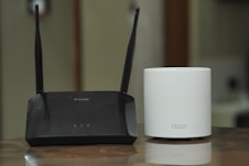 a couple of routers sitting on top of a table