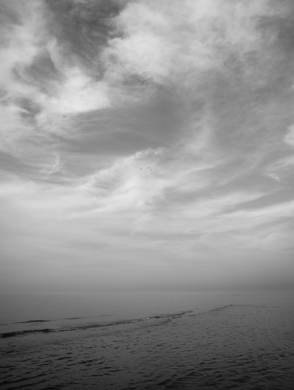 a black and white photo of the ocean