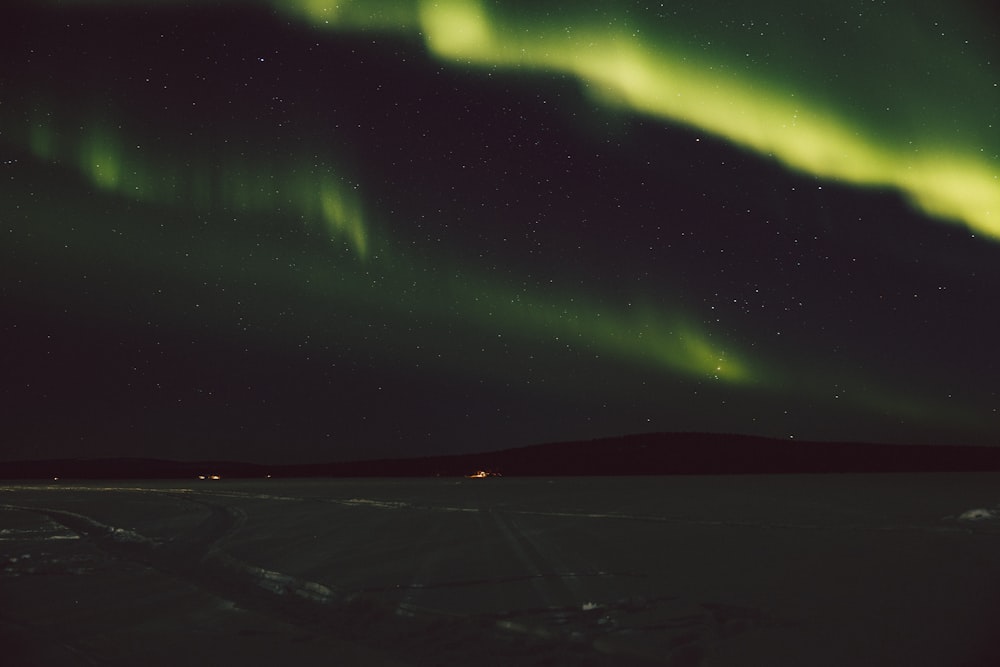 a green and yellow aurora bore in the night sky