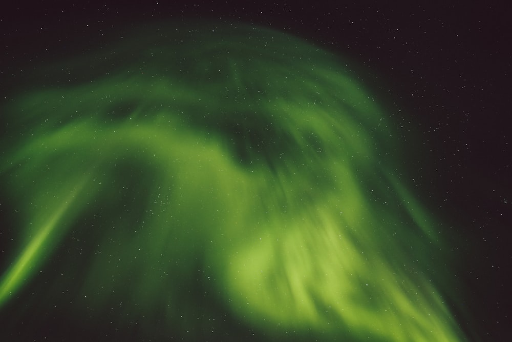 a green and white swirl in the night sky