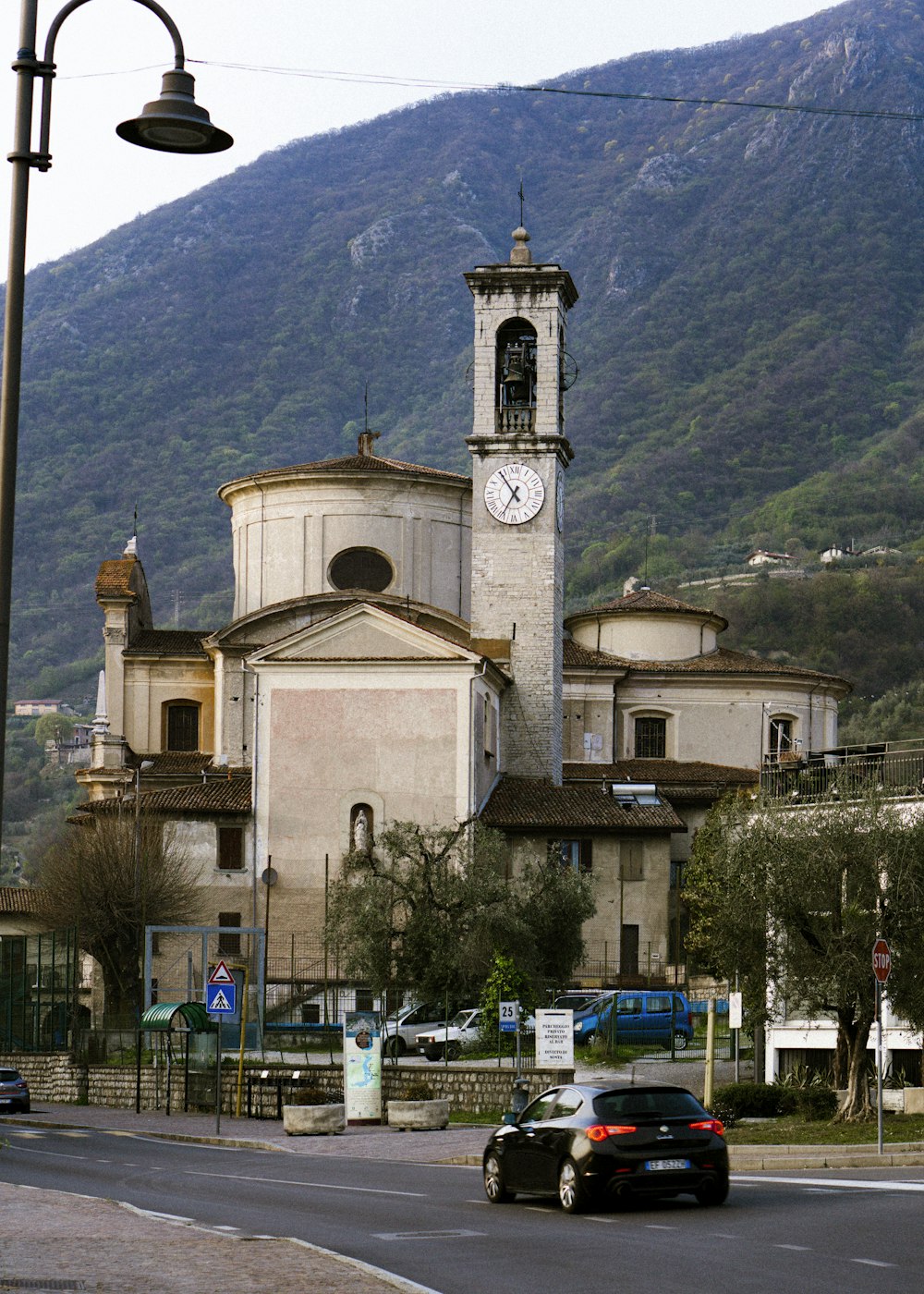 a car driving down a street next to a church