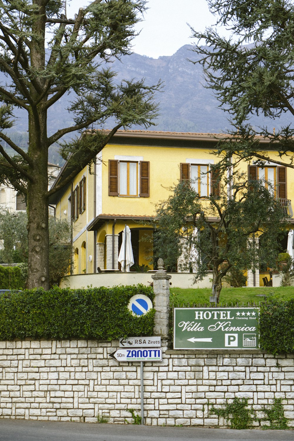 a yellow building with a sign in front of it