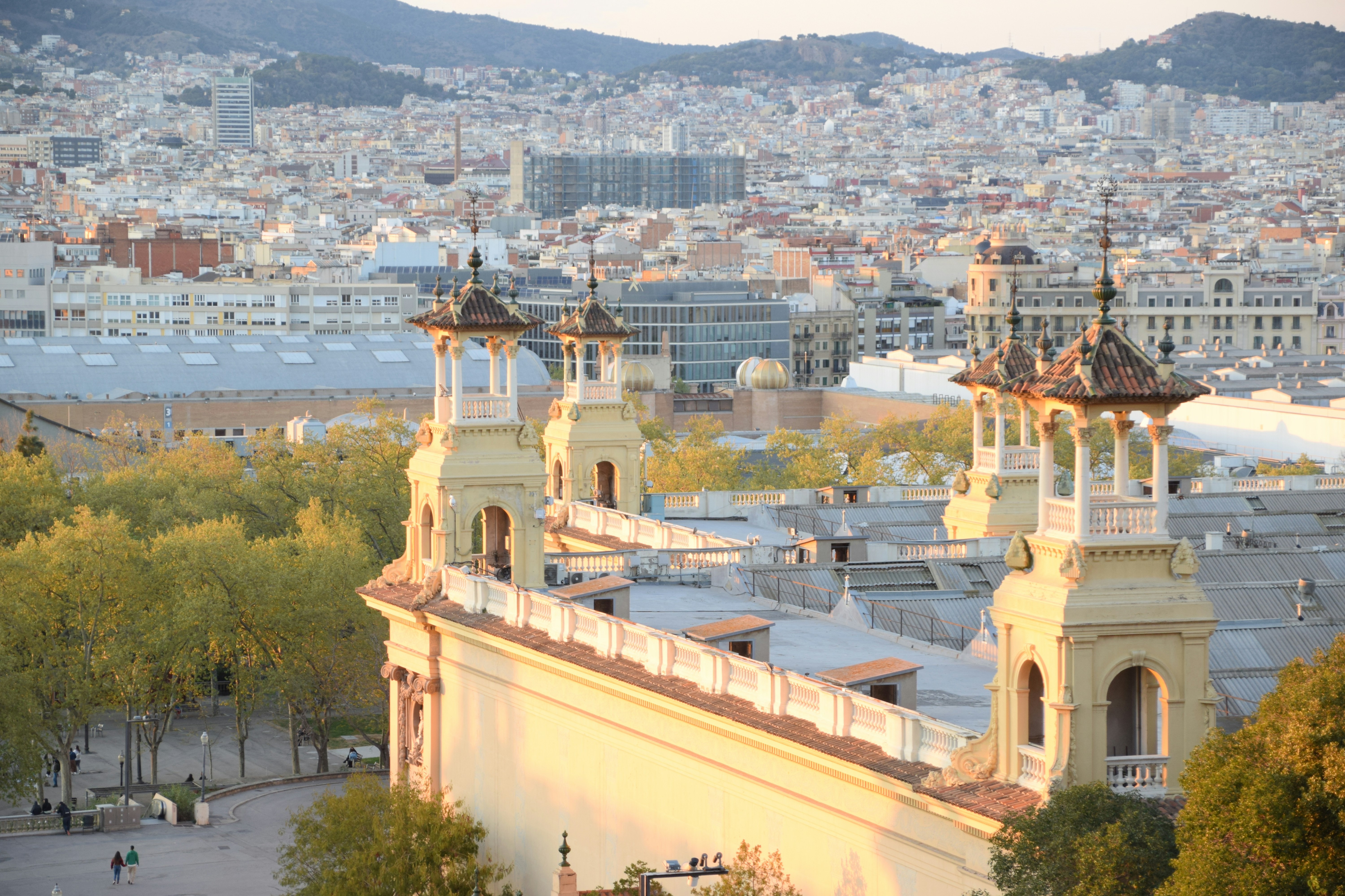 a view of a city with tall buildings, casual evening walk through Barcelona 7.04.23