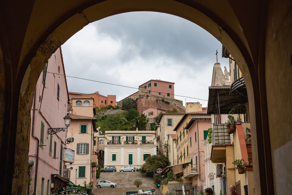 a view of a street with buildings and a hill in the background