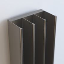 A metallic, four-slot vertical organizer is mounted on a light-colored wall. The organizer has a sleek and modern design, with smooth edges and a polished finish.