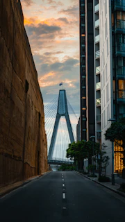 Sunset view of a completed bridge with smooth road surface and safety barriers
