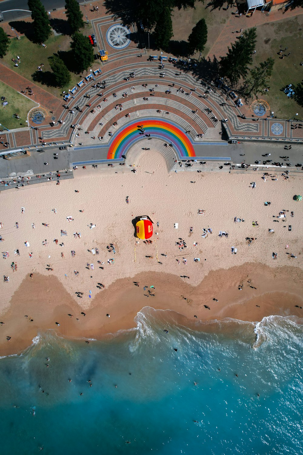 an aerial view of a beach with a rainbow in the background