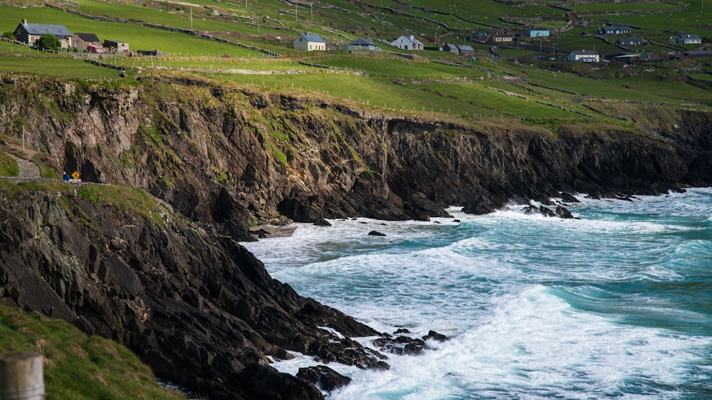 a rocky cliff overlooks a body of water