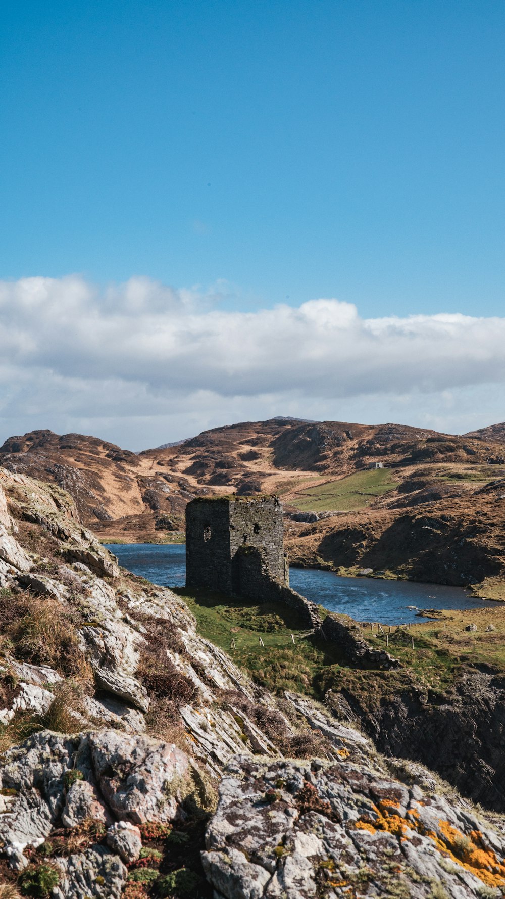 a stone tower sitting on top of a rocky hillside