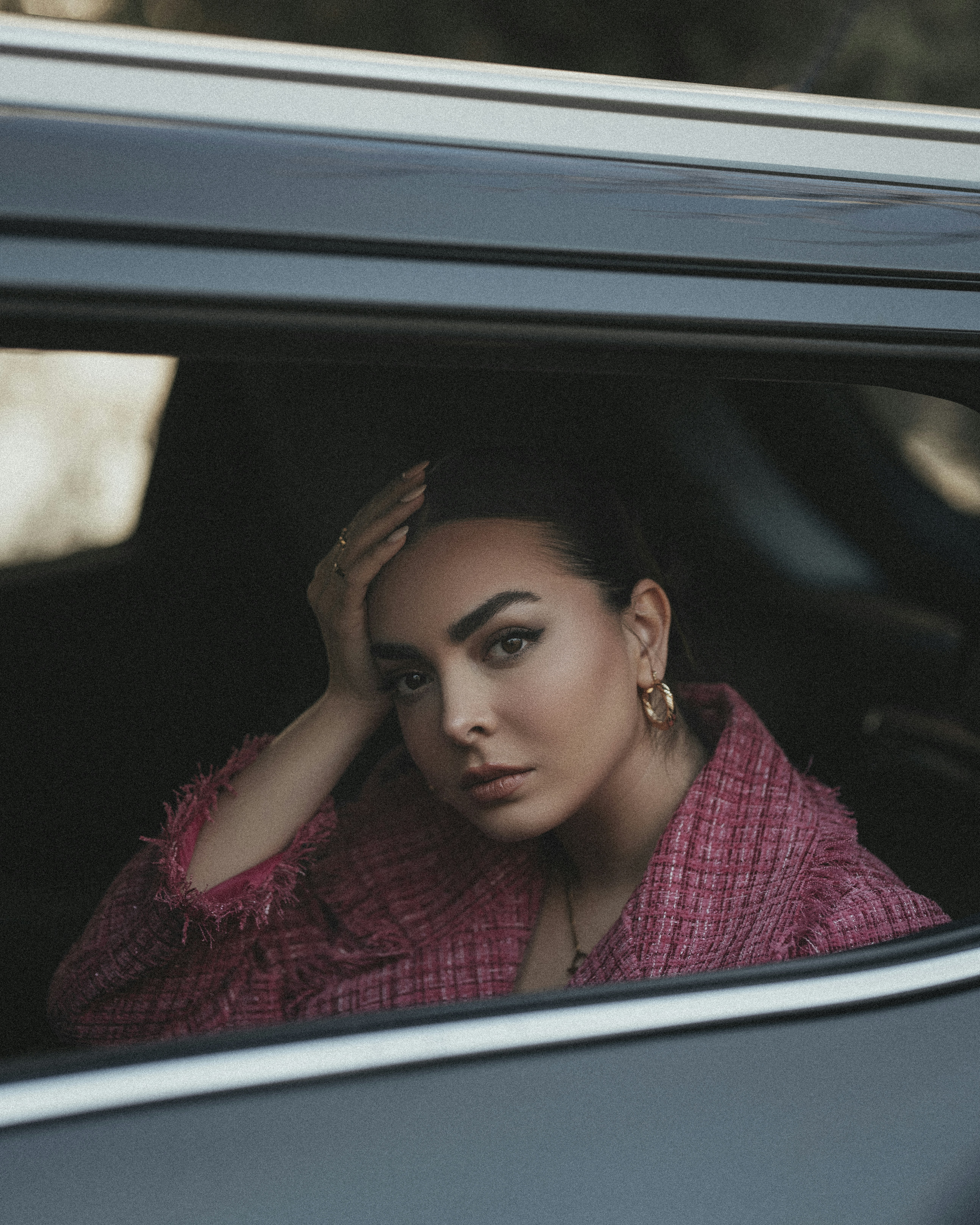 車に座って窓の外を眺める女性