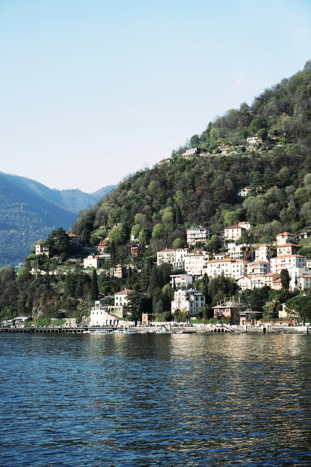 a small village on a hill above a body of water