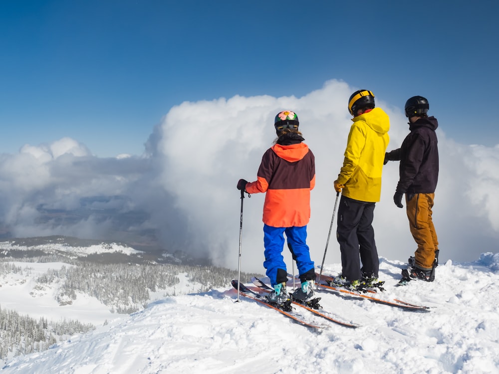 a group of people riding skis on top of a snow covered slope