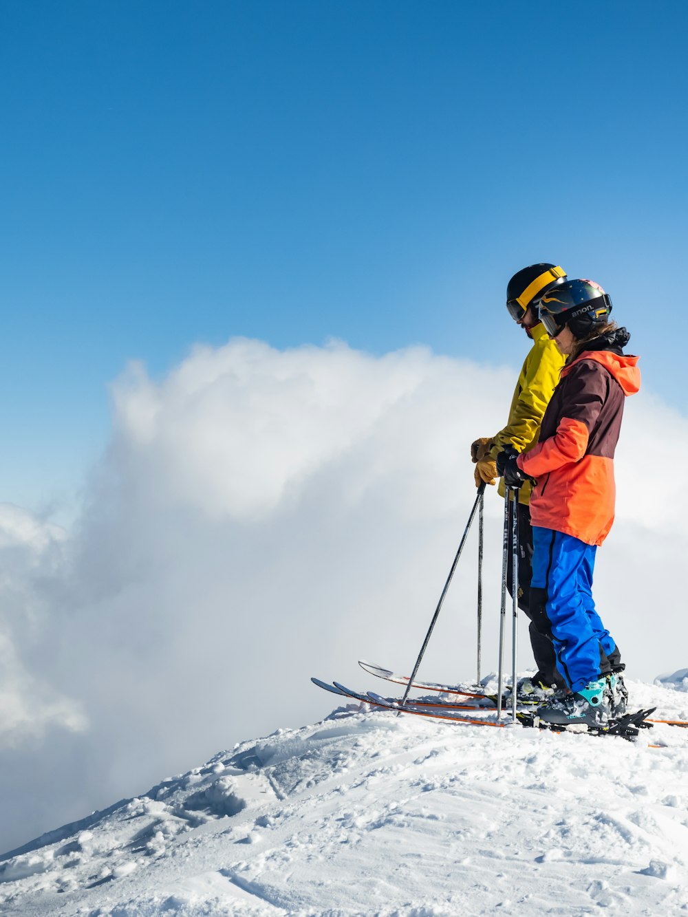 a man standing on top of a snow covered ski slope