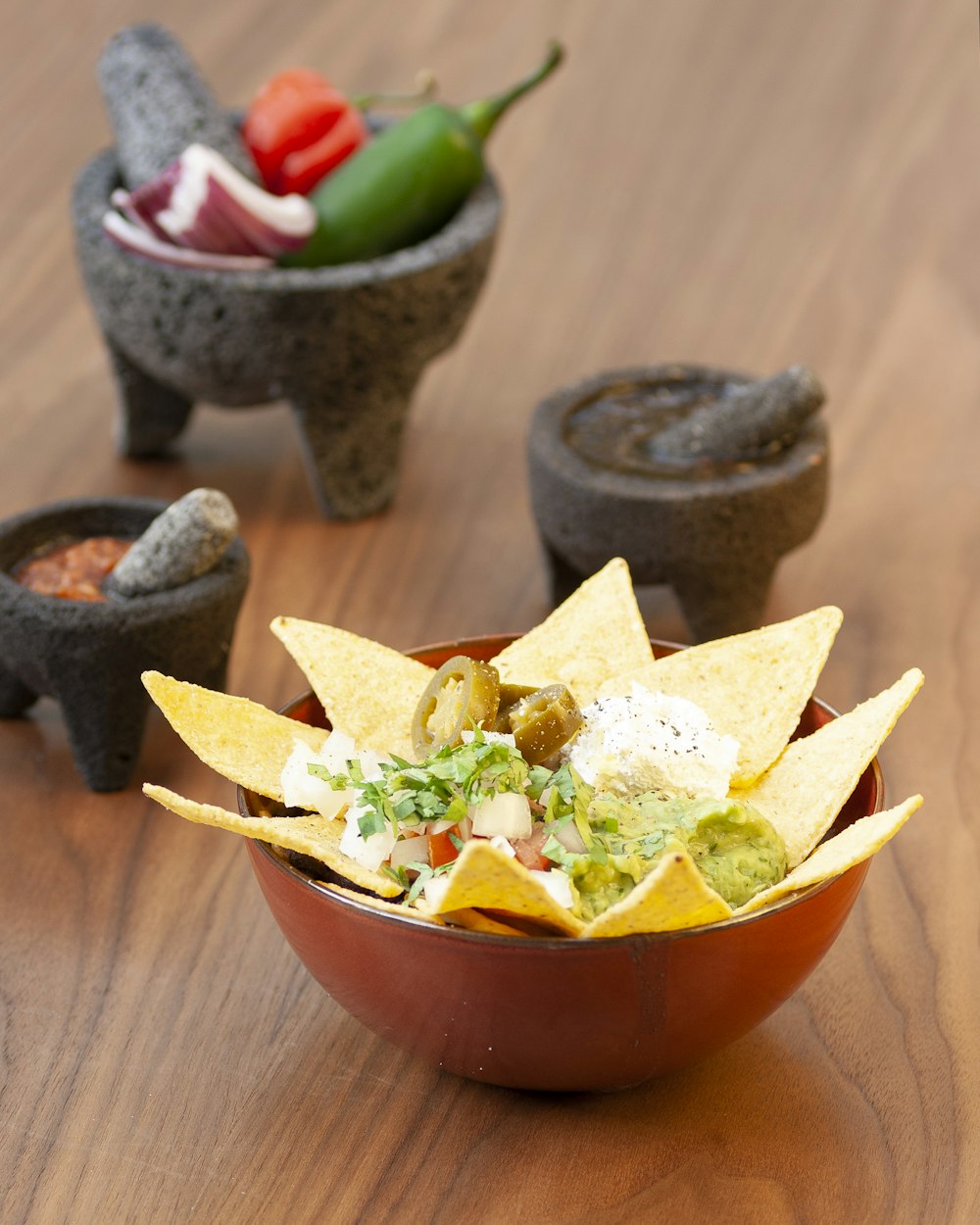 a bowl of nachos on a wooden table