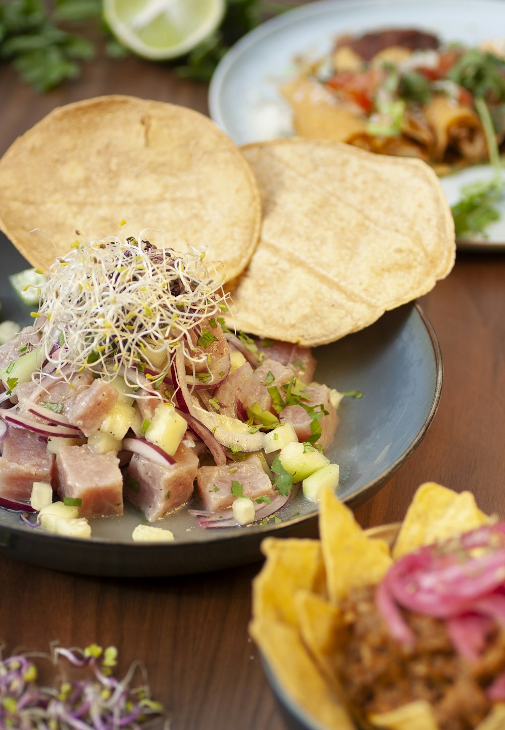 a wooden table topped with plates of food