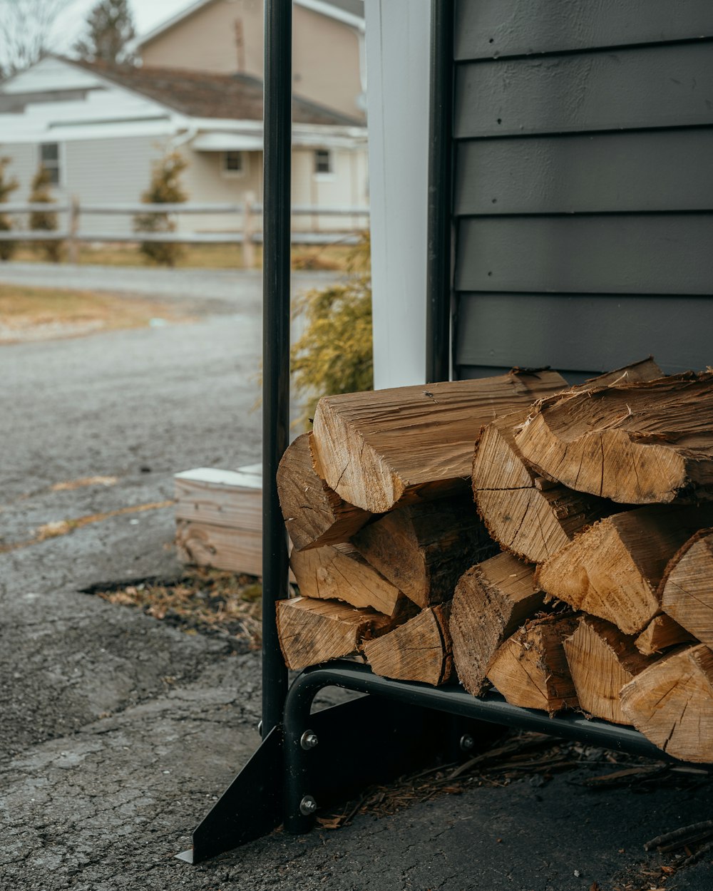 a pile of wood sitting in front of a house