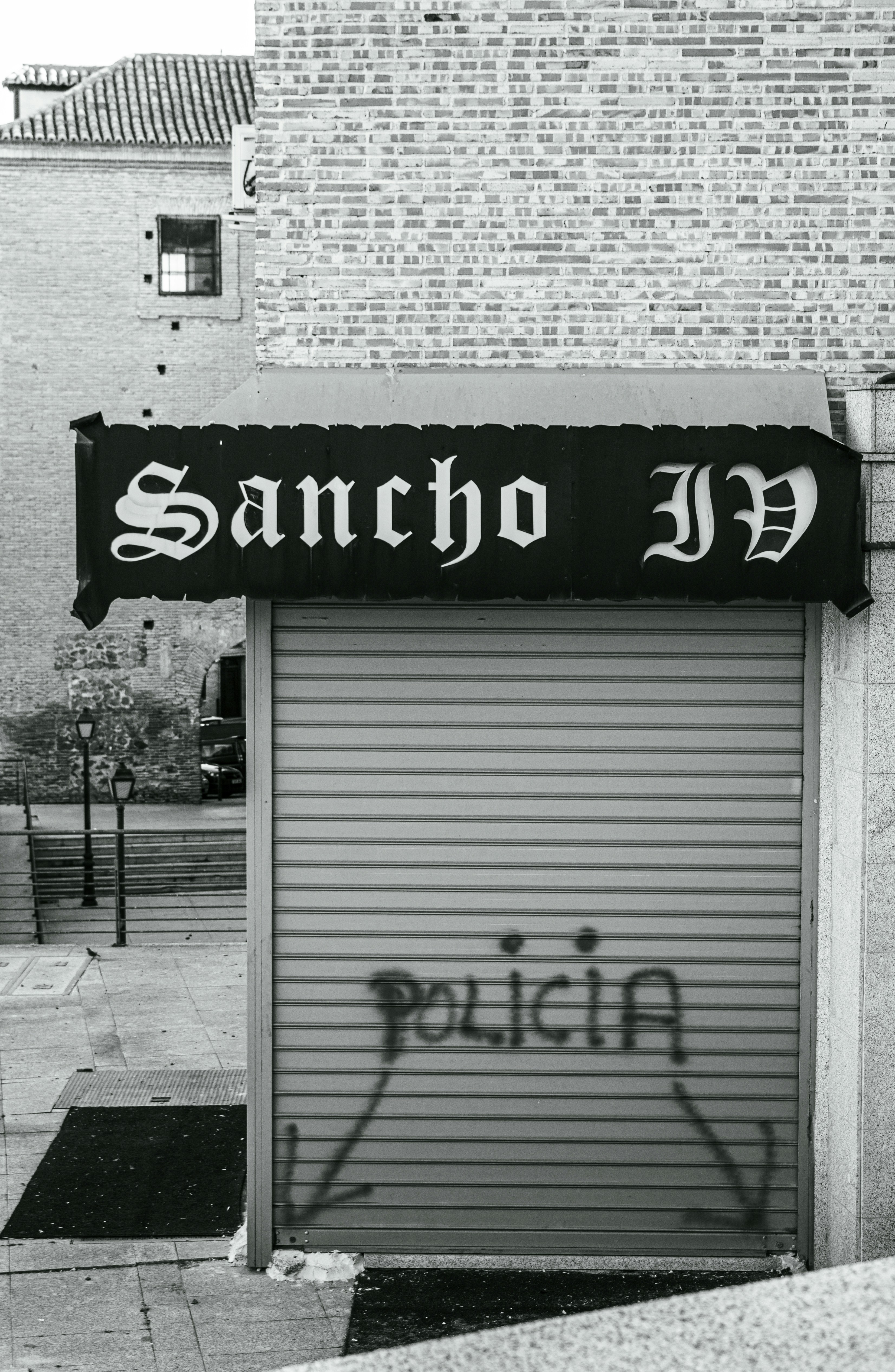 a black and white photo of a closed garage