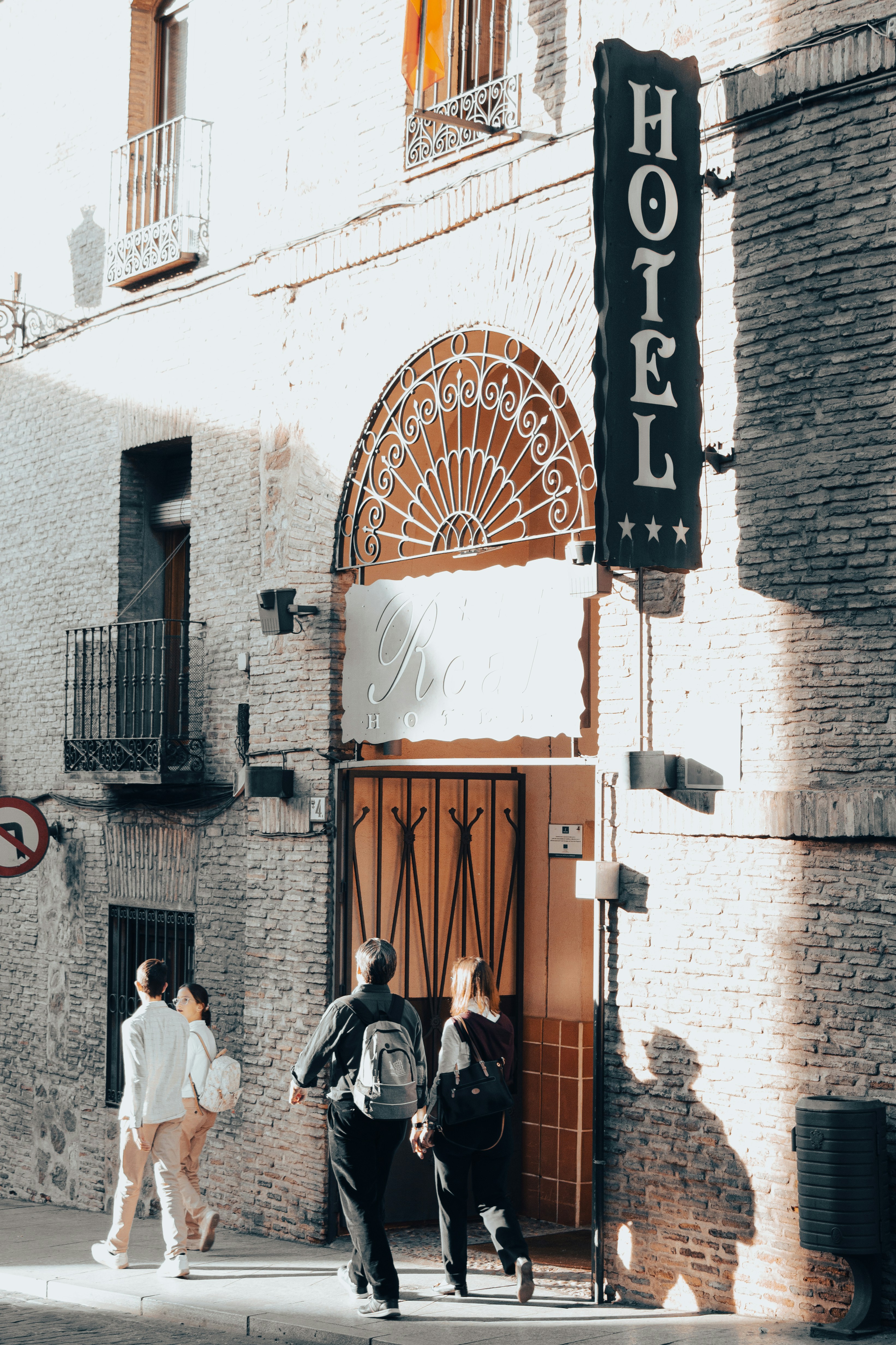 a group of people walking down a street next to a building