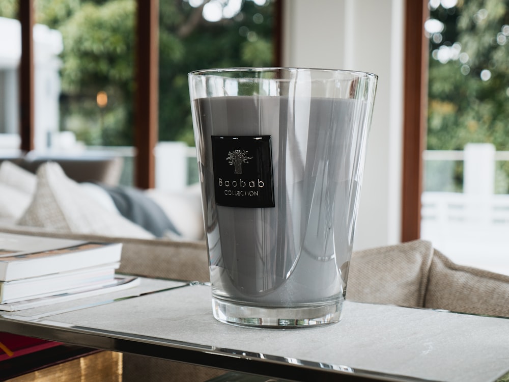 a glass filled with liquid sitting on top of a table