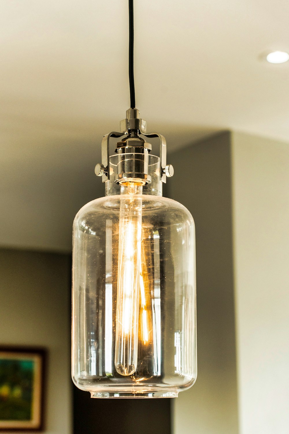 a clear glass light fixture hanging from a ceiling