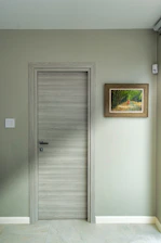 an empty room with a door and a picture on the wall