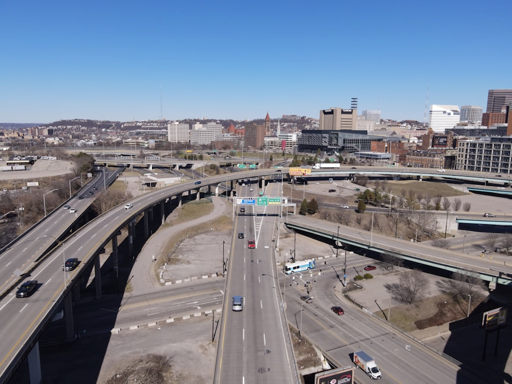 an aerial view of a highway with a bridge in the background