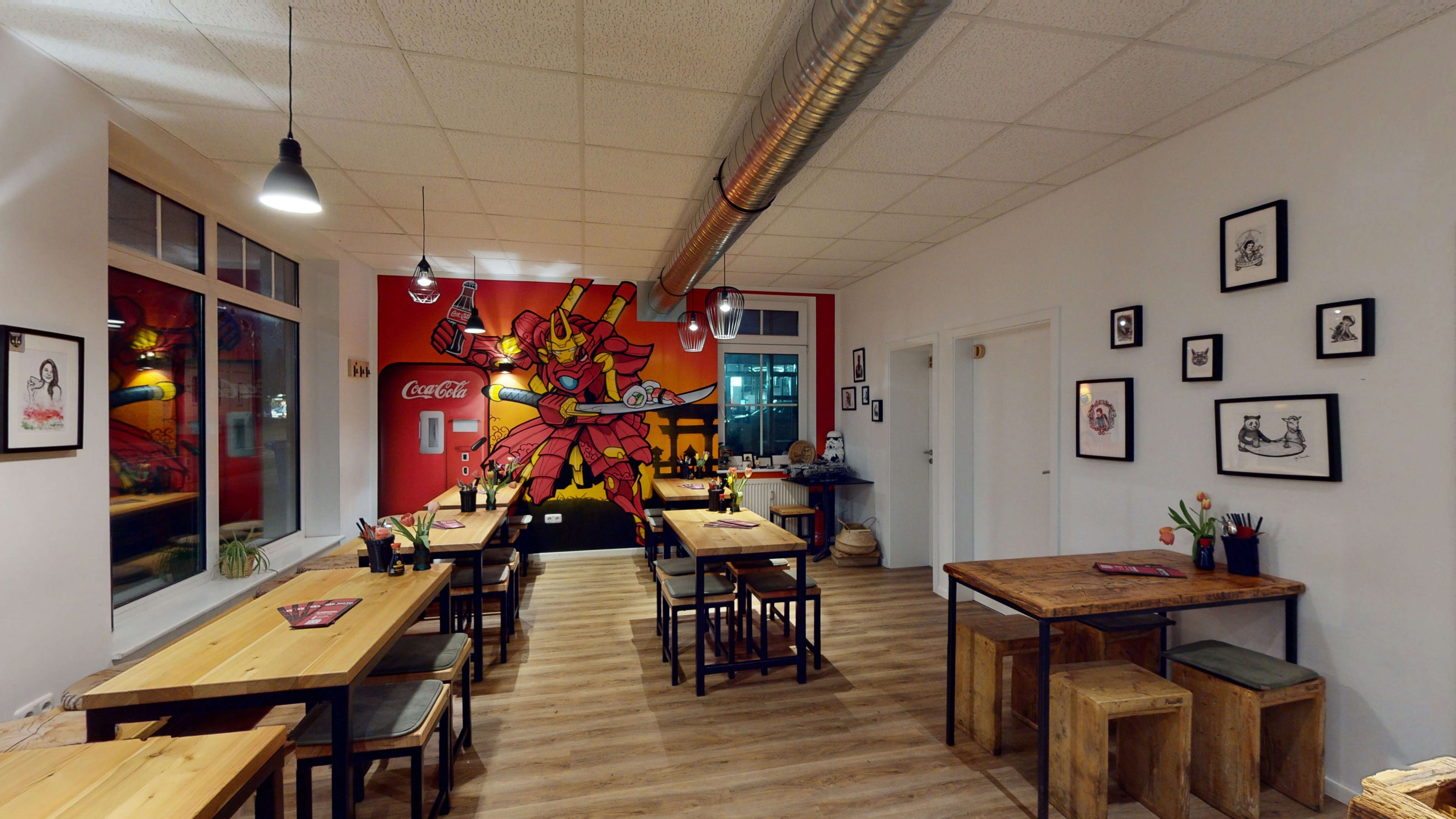 a restaurant with a large mural on the wall