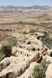a view of a village in the middle of the desert
