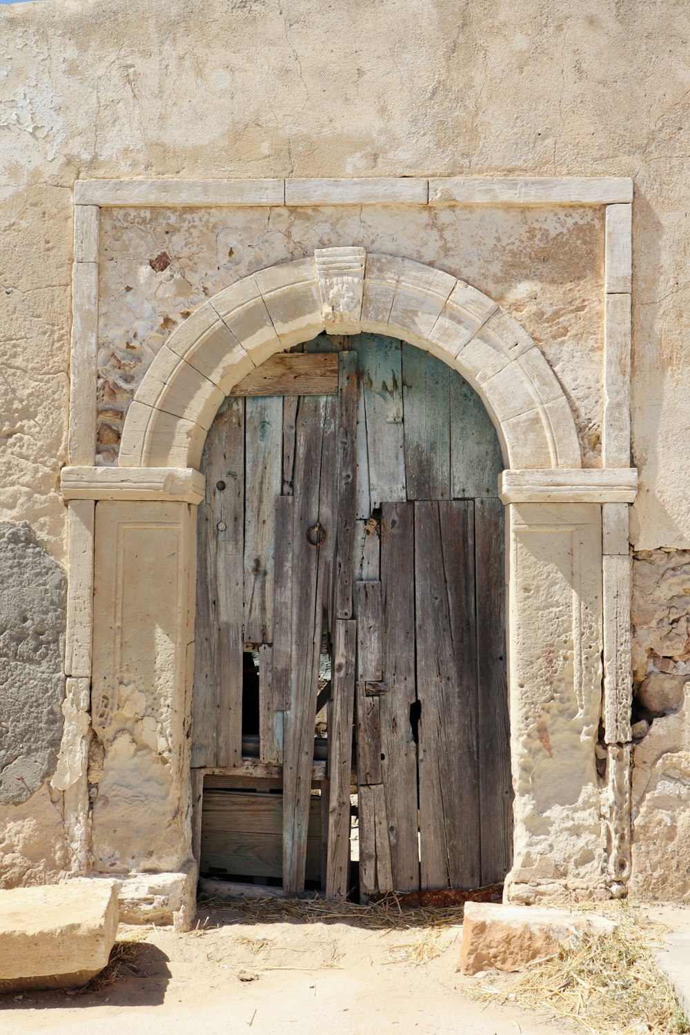 an old wooden door with a stone arch
