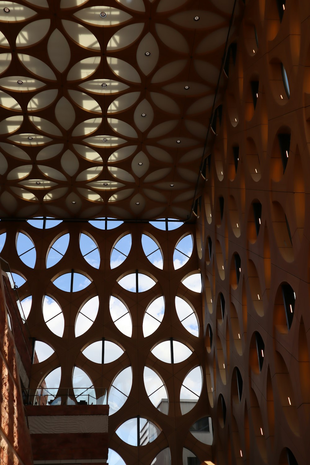 a building with a lot of circular holes on the ceiling